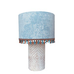 Table lamp with pale blue lamp shade